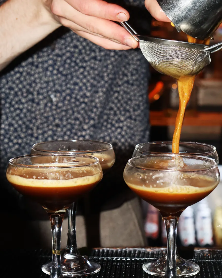 Espresso martinis being poured at the bar